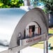 A silver stainless steel WPPO Karma 55 commercial pizza oven with a round door.