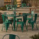 A Lancaster Table & Seating emerald green table with chairs on an outdoor patio.