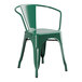 A Lancaster Table & Seating emerald green metal arm chair.