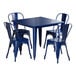 A blue metal Lancaster Table & Seating outdoor table with four chairs.