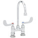 A T&S chrome deck-mount faucet with gooseneck spout and wrist action handles.