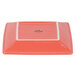 A square orange Tuxton Concentrix china plate with a white border.