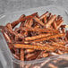 A container of Tom Sturgis Thick Stiks pretzels with sesame seeds.