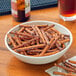 A bowl of Tom Sturgis Thick Stiks pretzels on a table.