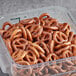 A plastic container filled with Tom Sturgis Little Ones pretzels.