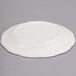 A CAC ivory china plate with a scalloped edge.