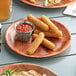 A Choice woven wood plate with food on a table.