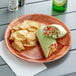 A Choice woven wood plate with food on it.