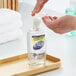 A person using Dial Sensitive Skin liquid hand soap in a soap dispenser.