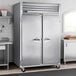 A Traulsen G Series reach-in freezer with two doors in a stainless steel kitchen.