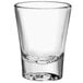 An Anchor Hocking clear shot glass with a white background.