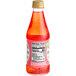 A close-up of a bottle of Rose's Strawberry Syrup with a red liquid inside and a label on it.