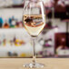 An Anchor Hocking Sondria wine glass filled with white wine on a table.