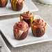 A marbled chocolate tulip cup filled with chocolate on a plate.