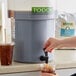 A person pouring Toddy cold brew coffee into a glass.