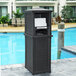 A black rectangular outdoor towel valet with a white towel on top.