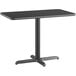 A black rectangular Lancaster Table & Seating table top with a metal base.