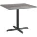 A Lancaster Table & Seating square table with a black base and slate gray top.