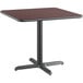 A Lancaster Table & Seating square table with a black base and a cherry top.