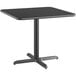 A black square Lancaster Table & Seating table top with a metal base.