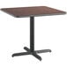 A Lancaster Table & Seating square table with a black base and a dark brown reversible top.