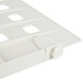 A close-up of a white plastic Metro shelf divider with four holes.