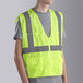 A person wearing a yellow Cordova Lime safety vest.