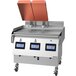A Garland Xpress natural gas clamshell griddle on a stainless steel counter.