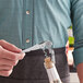 A person using an Acopa waiter's corkscrew to open a bottle of wine.