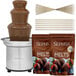A Sephra chocolate fountain with milk chocolate, bamboo skewers, and strawberries.