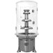 A metal and glass sneeze guard for a Sephra chocolate fountain.