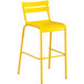 A yellow barstool with a white back.