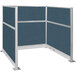 A Versare Hush Panel Caribbean U-Shape cubicle with blue fabric panels and two metal legs.