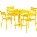 A yellow Lancaster Table & Seating outdoor table with chairs set up on an outdoor patio.