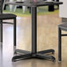 A black Lancaster Table & Seating column table base with two chairs and a table.