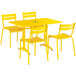 A yellow Lancaster Table & Seating outdoor table and chairs set.