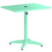 A Lancaster Table & Seating seafoam green table with a black umbrella hole.