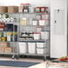 Regency metal wire shelving with food items on the shelves in a school kitchen.