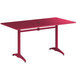 A red rectangular Lancaster Table & Seating outdoor table with metal legs.