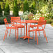 An orange table and chairs on a patio.