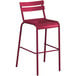 A red bar stool with a white metal frame.