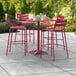 A Lancaster Table & Seating bar set with four chairs in sangria powder-coated aluminum on a patio.