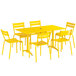 A yellow Lancaster Table & Seating outdoor table and chairs set.