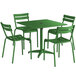 A Lancaster Table & Seating green metal table with four green chairs and an umbrella hole.