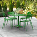 A green table and chairs on an outdoor patio.