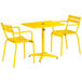 A yellow Lancaster Table & Seating outdoor table with two chairs.