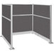 A Versare charcoal gray cubicle with silver metal corners.