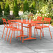 An orange table and chairs on a patio.