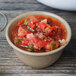A GET Tahoe Sandstone bowl filled with salsa on a wood surface.