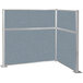 A white metal frame with powder blue fabric panels forming an L-shaped cubicle.